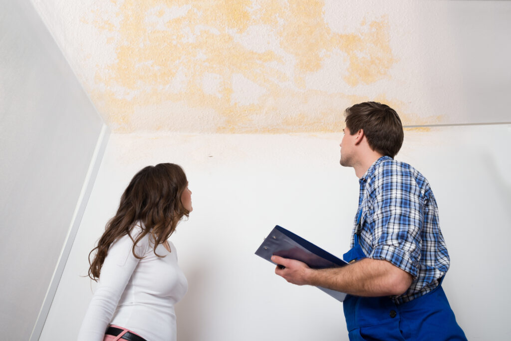 Homeowner and Technician Discussing a Ceiling Water Stain - K-Guard Heartland