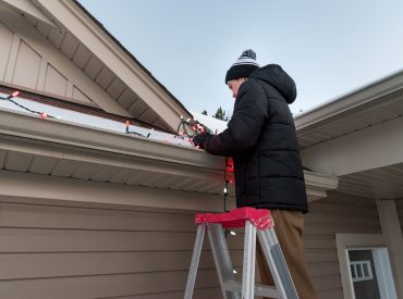 hanging Christmas lights on gutters