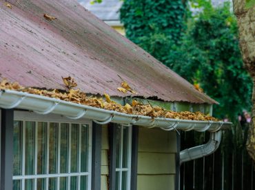 Dirty,Roof,With,Iron,Gutter,With,Autumn,Leaves,Requiring,Cleaning